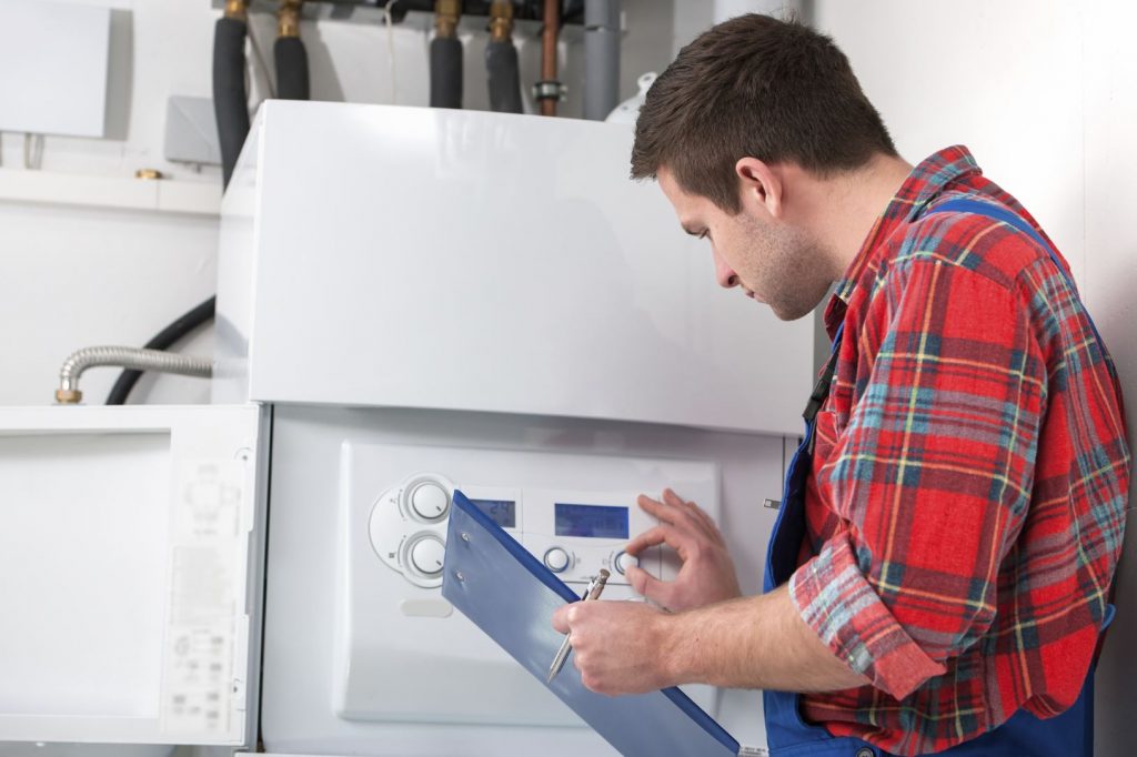 Heating engineer servicing a domestic boiler